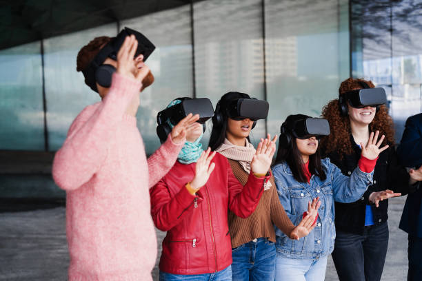 istock Young people wearing virtual glasses outdoor - Metaverse concept 1418146520