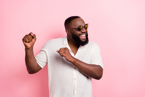 istock Photo of charming cool young man wear white shirt dark eyewear dancing isolated pink color background 1418146721