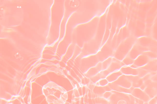 istock Defocus blurred transparent pink colored clear calm water surface texture with splashes and bubbles. Trendy abstract nature background. Water waves in sunlight with copy space. Pink watercolor shining 1418148903