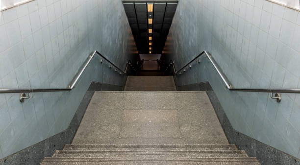 istock Looking down passageway stairs to subway station 1418154350
