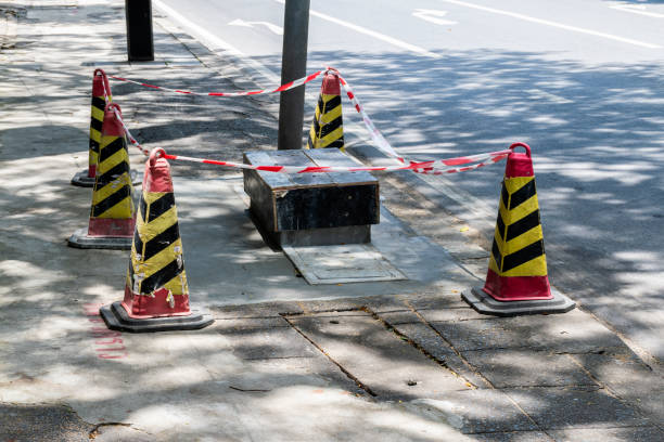 istock Sewer repair work with signal cones on footpath 1418154841
