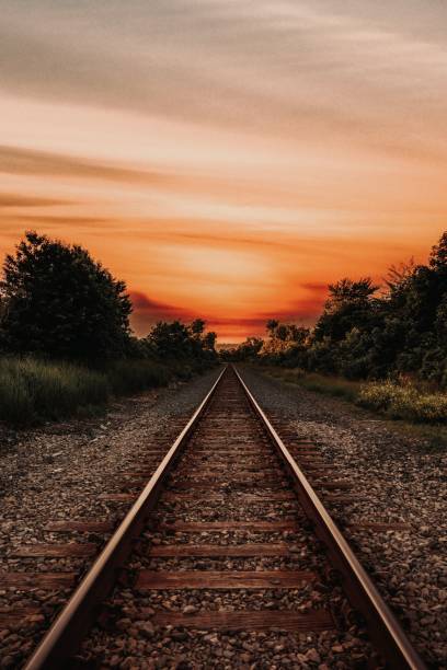 istock Vertical shot of the railways on a sunset 1418155667