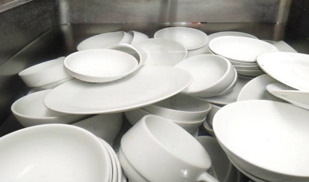 istock Top view many dirty dishes in kitchen sink 1418156207