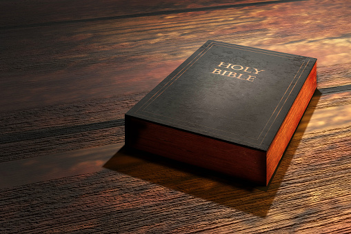 Holy Bible on wooden table. 3D render illustration.