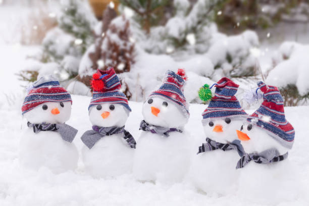 istock Five cute snowmen  dressed for winter 1418158289