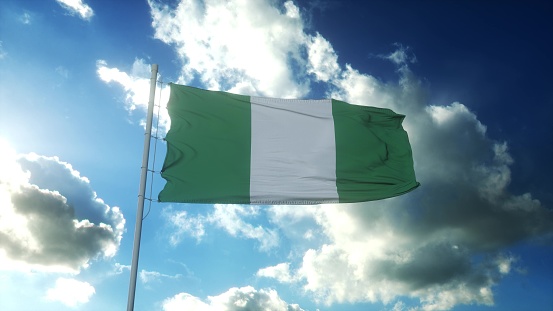 Flag of Nigeria waving at wind against beautiful blue sky. 3d illustration.