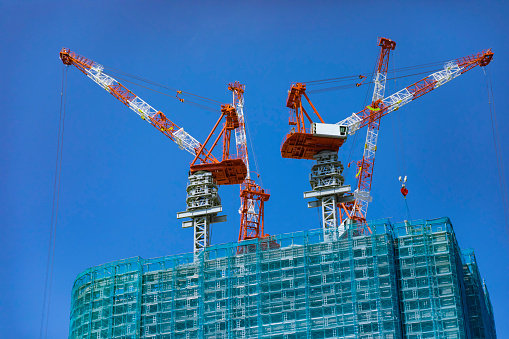 Cranes at the under construction daytime. High quality photo. Minato district Iikurakatamachi Tokyo Japan 08.09.2022 It is center of the city in Tokyo.