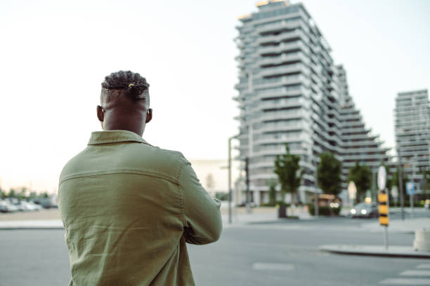 istock Young Afro American man looking at cityscape 1418160684