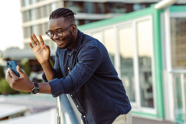 istock Young man communicating on a video call outdoors 1418160925