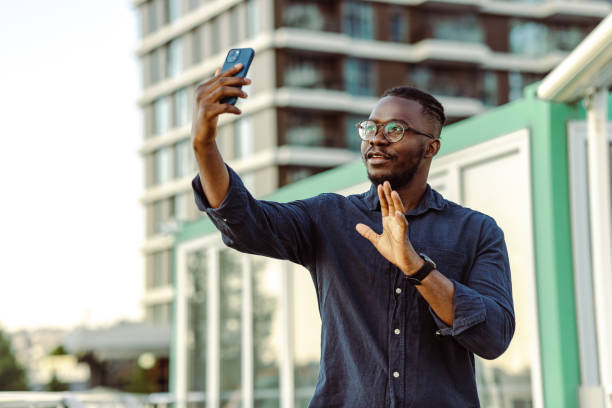 istock Young man communicating on a video call outdoors 1418160927