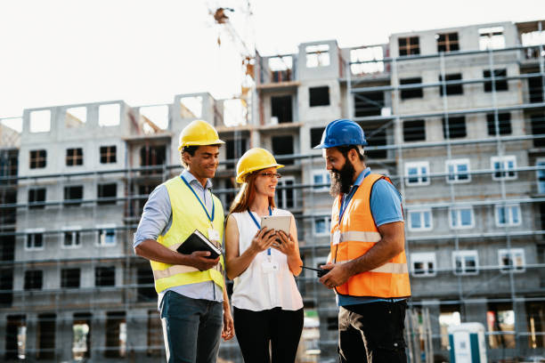 istock Construction industry and engineering - Female engineer, architects and contractors on the construction site 1418161566