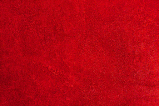 Beautiful red background with leather texture with red veins of red leather as sample of red background from natural leather or sample of texture of leather for beautiful natural background