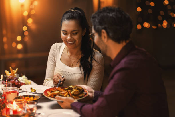 happy couple eating at christmas dinner