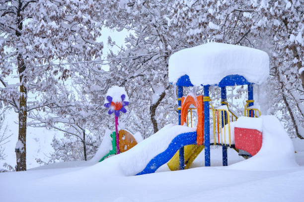 istock children's slide under the snow. 1418165621