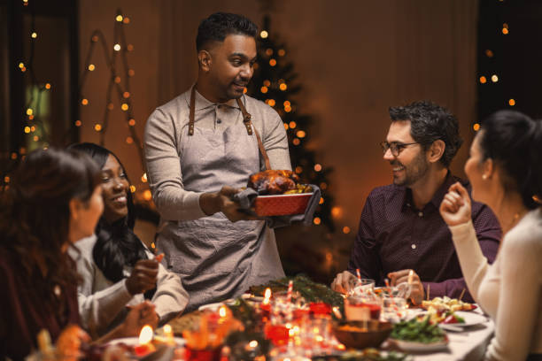 istock happy friends having christmas dinner at home 1418165676