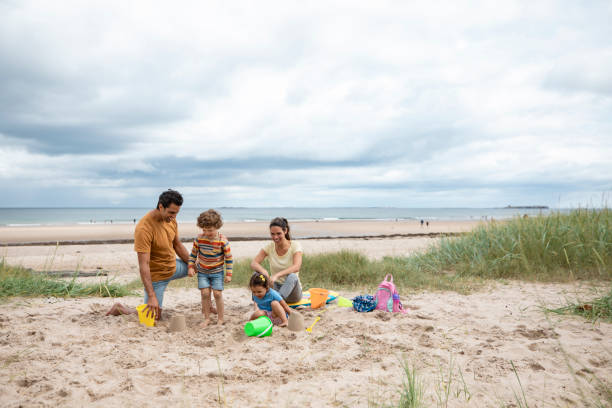 istock Family Building Sand Castles 1418167333