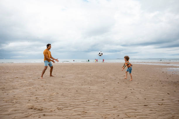 playing catch on the beach - playing catch imagens e fotografias de stock