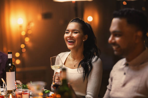 istock happy friends drinking wine at christmas party 1418167701