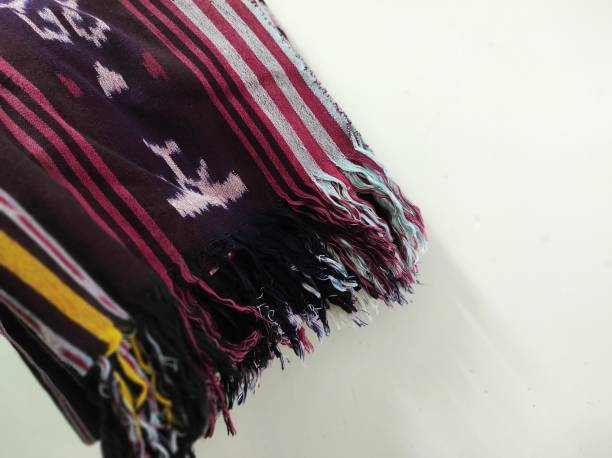 istock Indonesian woven fabric on a white background 1418167781
