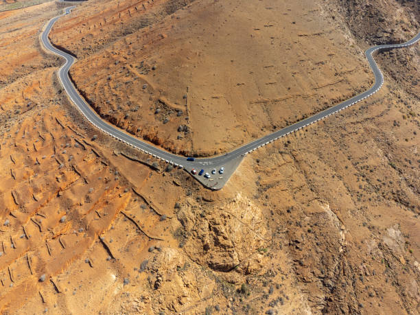 istock road on the side of a mountain with a triangular parking lot over a precipice in the arid wasteland Fuerteventura 1418168497