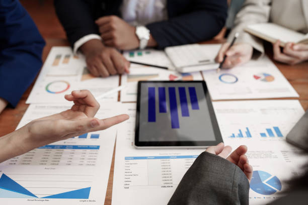 istock Analytics intelligence concept. Group of business people discuss current financial and economic on laptop for investment at the meeting 1418168516