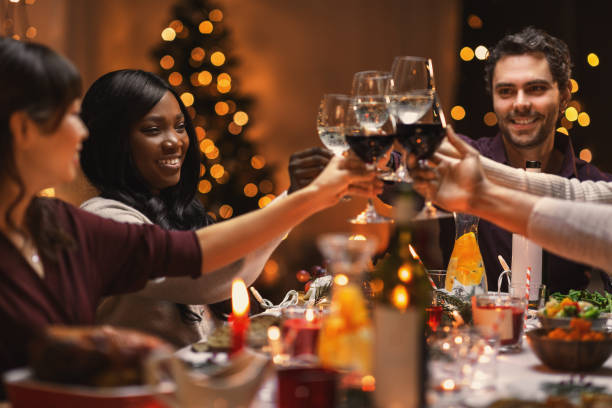 istock happy friends drinking wine at christmas party 1418168906