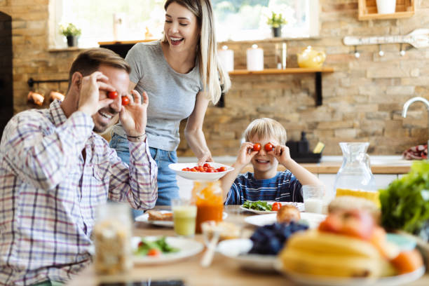 istock Happy family having fun while enjoying in lunch time 1418168968