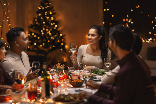 istock happy friends drinking wine at christmas party 1418169068