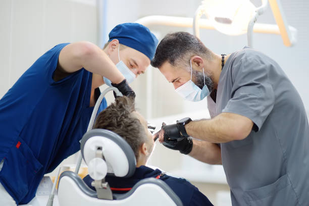 surgeons during a dental operation. anesthetized patient in the operating room. installation of dental implants in the clinic. - caucasian cavity clinic color image imagens e fotografias de stock