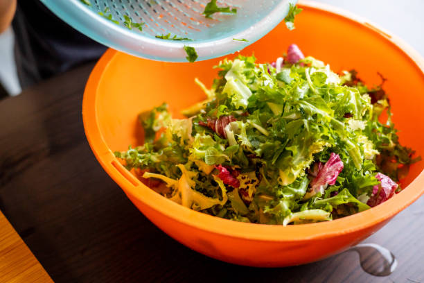istock mix green leaf salads close up on kitchen table at home 1418169485