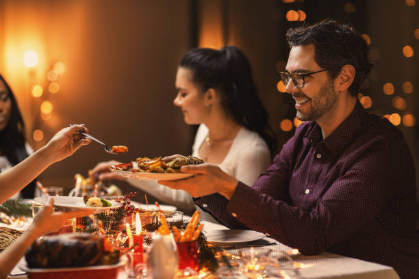 istock happy friends having christmas dinner at home 1418169520