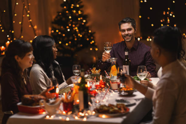 istock happy friends drinking wine at christmas party 1418169544