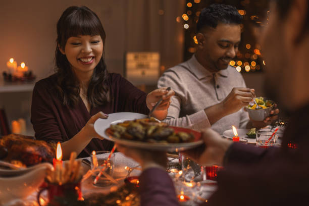 istock happy friends having christmas dinner at home 1418171102