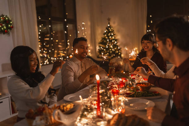 istock happy friends with sparklers at christmas dinner 1418171538