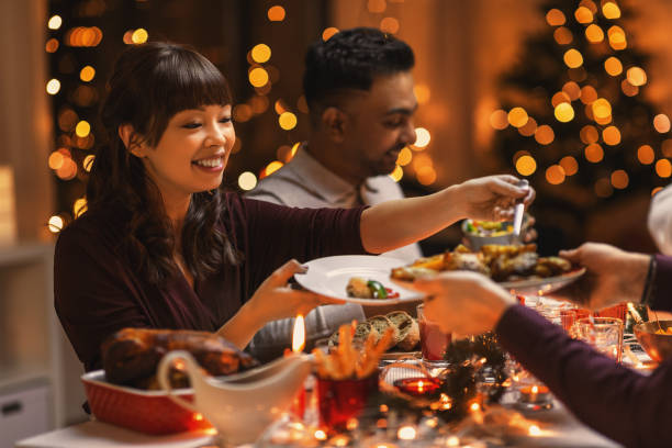 istock happy friends having christmas dinner at home 1418171566