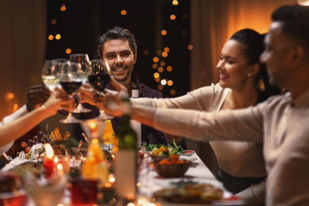 istock happy friends drinking wine at christmas party 1418171591