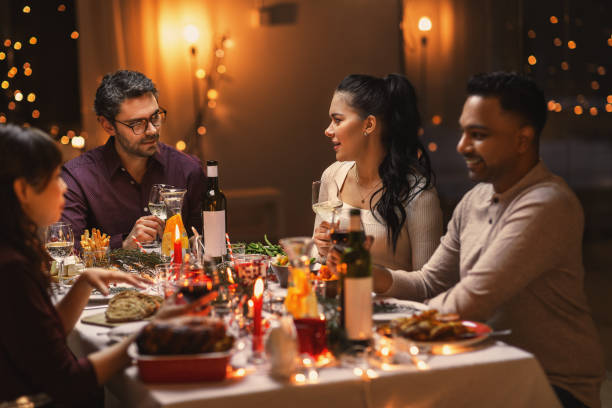 istock happy friends drinking wine at christmas party 1418171701