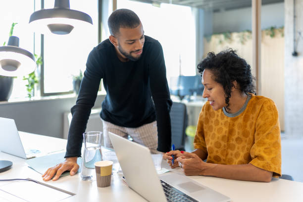 istock Colleagues discuss issues in a modern startup office and conference room. 1418171796