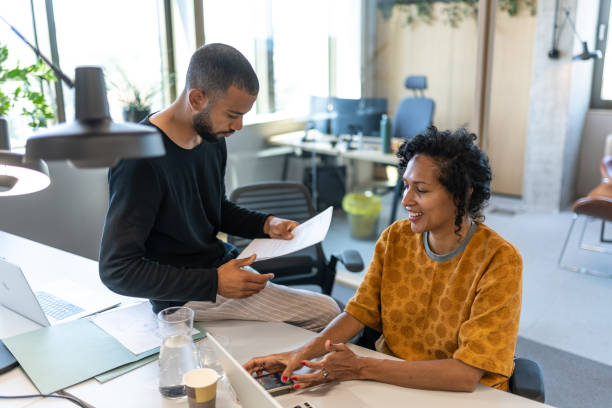 istock Colleagues discuss issues in a modern startup office and conference room. 1418171799