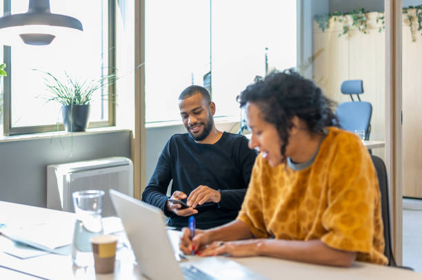 istock Colleagues discuss issues in a modern startup office and conference room. 1418171905