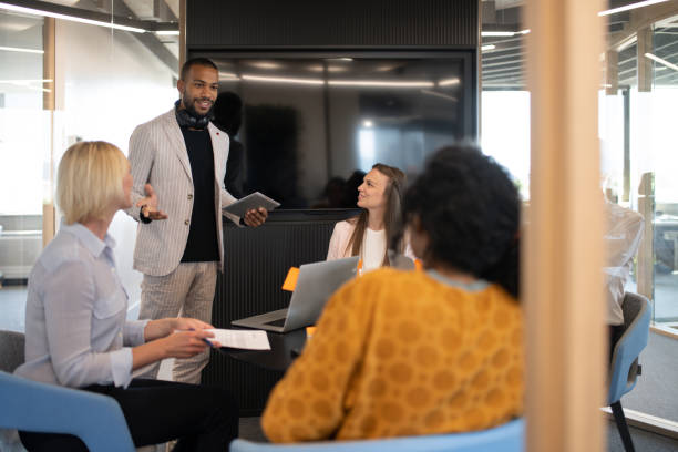 istock Colleagues discuss issues in a modern startup office and conference room. 1418171963
