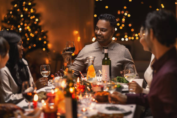 istock happy friends drinking wine at christmas party 1418172012