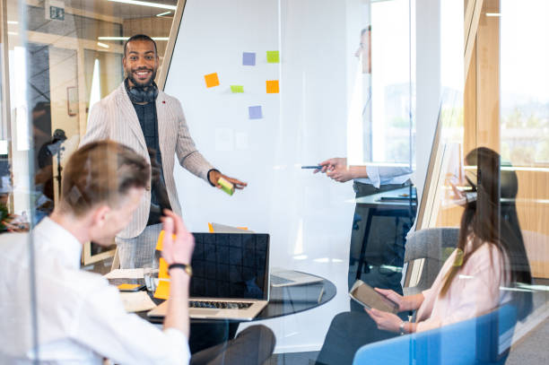 istock Brainstorming of colleagues about issues in a modern startup office and a conference room. 1418172131