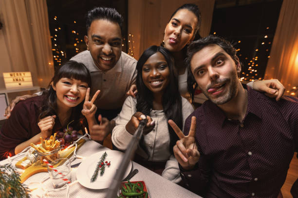 istock friends taking selfie on christmas dinner at home 1418172689