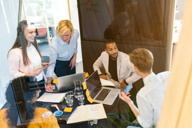 istock Brainstorming of colleagues about issues in a modern startup office and a conference room. 1418172842
