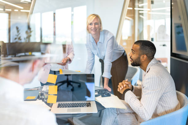 istock Brainstorming of colleagues about issues in a modern startup office and a conference room. 1418172847