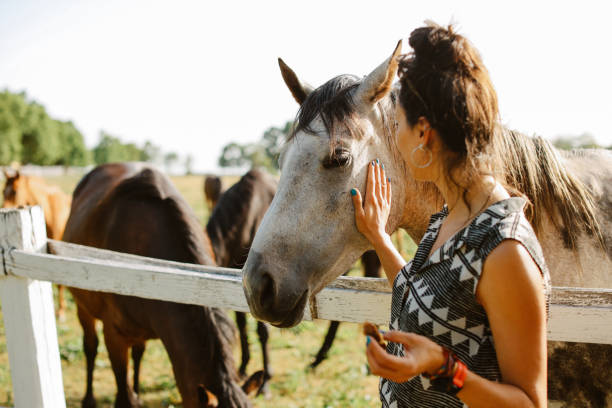 istock woman spending time on the horses ranch 1418173480
