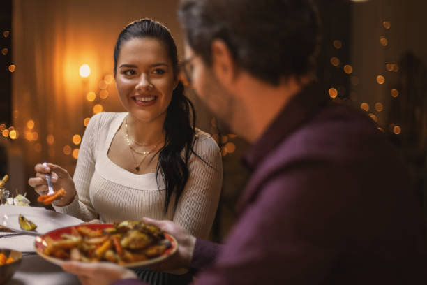 istock happy friends having christmas dinner at home 1418173560