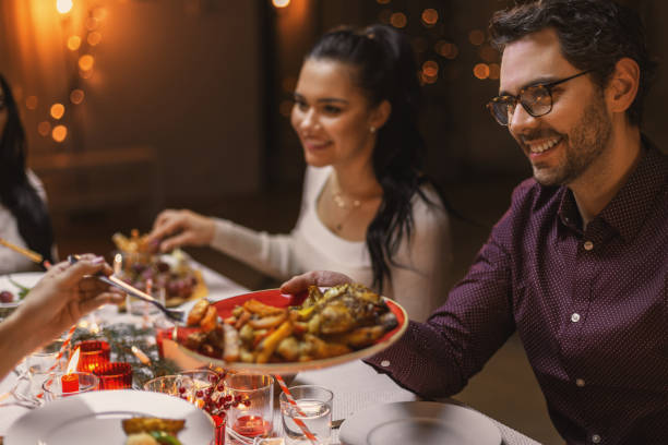 istock happy friends having christmas dinner at home 1418173640