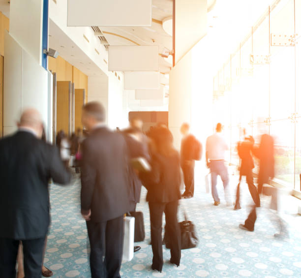 istock business people rushing in the lobby. motion blur 1418173713